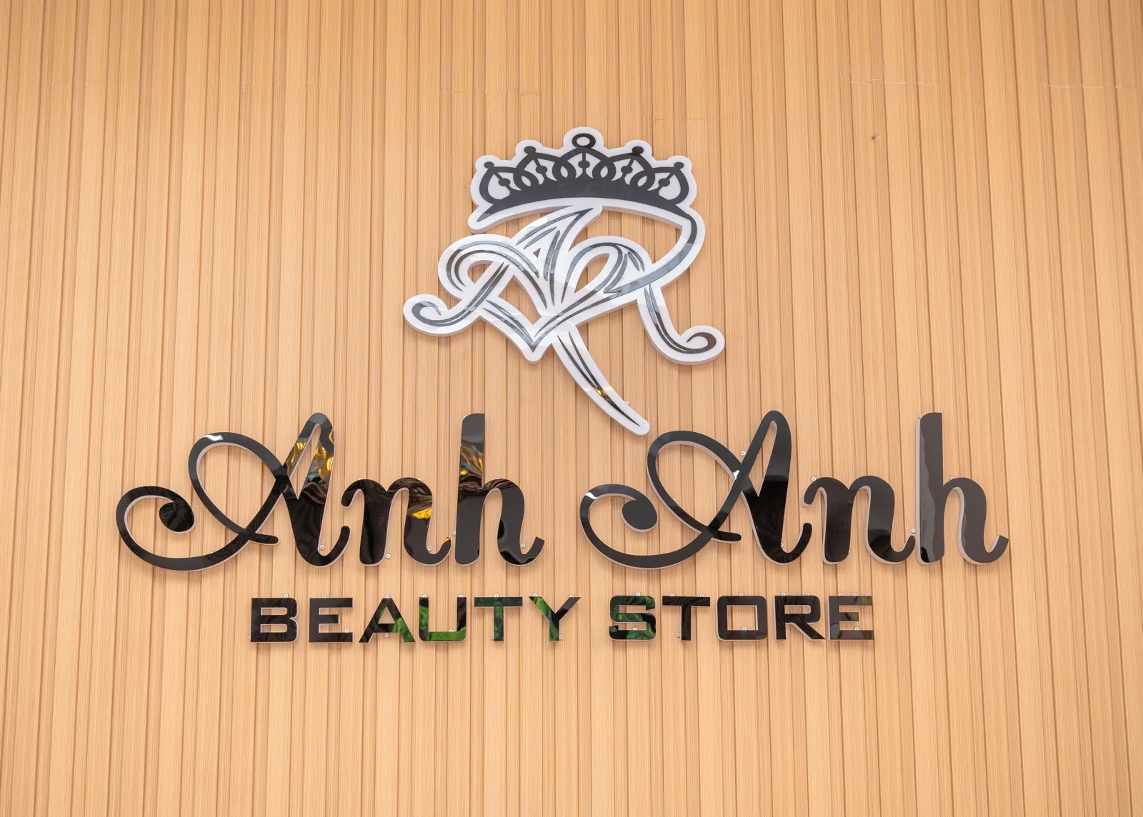 Black Anh Anh Beauty Store lettering on a wooden wall