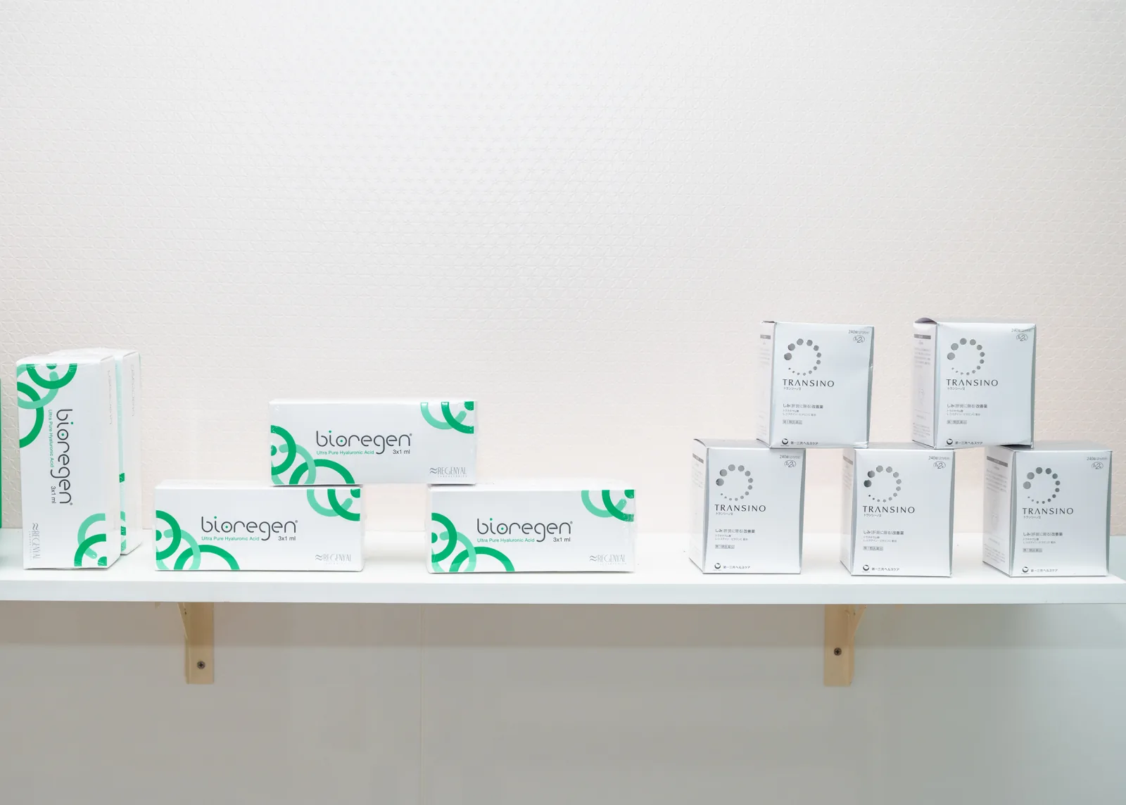 Skin-care boxes on white wall-mounted shelves